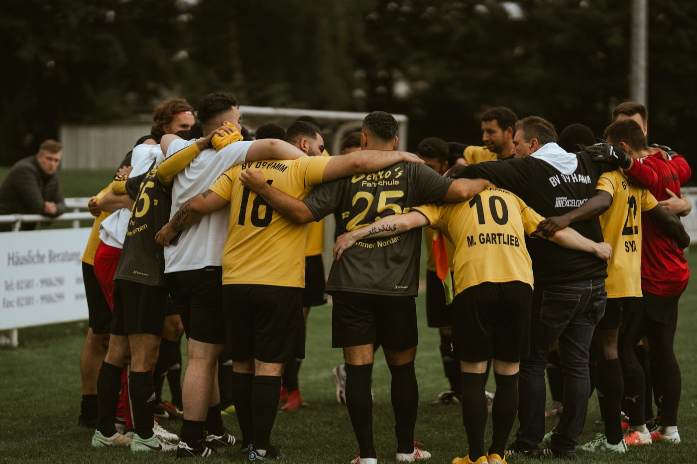 A team huddled together on the pitch